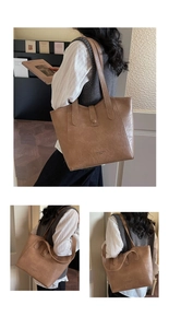 Detail view of the brown leather tote bag featuring Fashion Trend embossed text and stitching