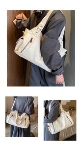 Detail shots of off-white large capacity tote bag with soft leather texture and metal zippers