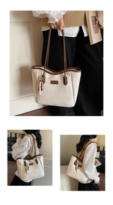 Close-up of cream tote bag with brown straps and elegant beaded fringe detail