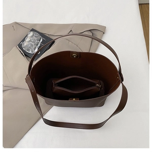 Top view of large brown matte leather tote bag with matching inner pouch and magnetic closure