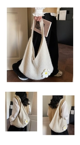Close-up of white knit shoulder bag with woven mesh pattern and 3D daisy flower detail