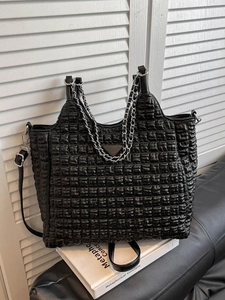 Chic black pleated tote bag with metal chain handle and iconic triangular plaque
