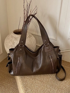 Large dark brown vintage soft leather tote bag with decorative zippers and top handle