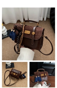 Detail of vintage brown satchel with teddy bear charm and textured leather stitching