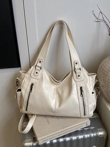 Large cream tote bag in textured faux leather with double zipper detail and carry handles
