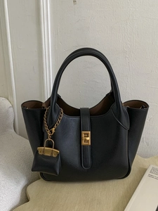 Minimalist black PU leather tote bag with gold twist lock and mini bag charm detail