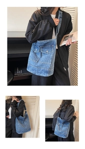Detail of blue washed denim tote bag with two front flap pockets and shoulder straps