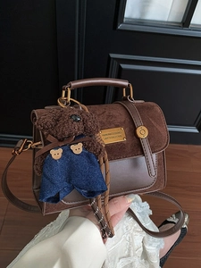 Vintage dark brown satchel bag with teddy bear pendant and adjustable shoulder strap