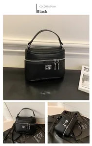 Detail of black box bag with lychee texture leather and silver metal decorative lock
