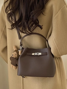 Classic dark brown pebble leather bucket bag with silver lock and teddy bear charm