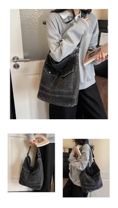 Detailed view of charcoal washed denim tote bag featuring dual front pockets and large capacity