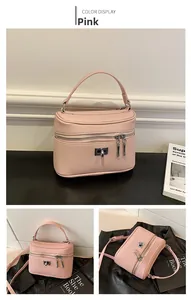 Detailed views of pink pebbled leather crossbody bag with silver twist lock and dual zippers