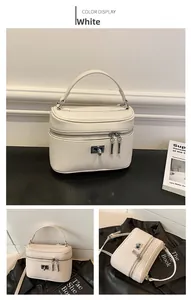 Detail view of the white box handbag featuring high-quality lychee grain leather texture