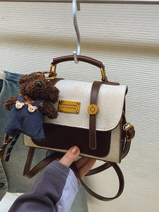 Vintage beige and brown contrast satchel with gold hardware and a cute plush bear charm