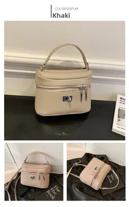 Detail view of khaki box crossbody bag with lychee texture and metal swivel lock