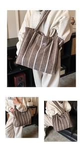 Detail shot of a brown striped tote bag with a decorative white bow and thick fabric