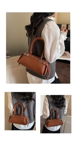 Close-up of brown litchi pattern leather baguette bag with silver buckles and strap detail