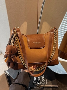 Vintage brown leather crossbody bag with chain strap and teddy bear charm for women