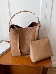 Camel matte tote bag set with large bucket bag and pouch on a wooden tabletop