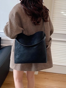 Matte black large capacity tote bag shown on model back for casual daily office commute