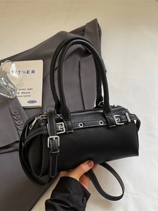 Vintage black cylinder baguette bag with white stitching and belt buckle details