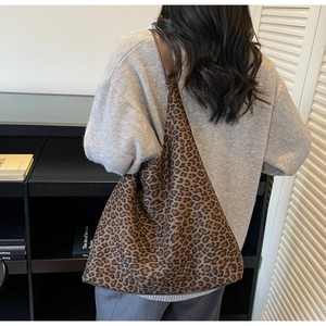 Detail of hobo bag with classic leopard print and premium dark brown leather shoulder strap