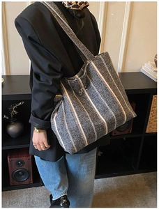 Detail of grey striped cotton tote bag showing large capacity and soft texture