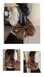 Macro view of vintage brown PU leather tote bag with lace edges and large bow detail