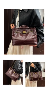 Close-up of burgundy quilted tote bag featuring gold rotary lock and chain strap