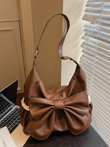 Vintage brown leather tote bag with a large bow and white lace trim detail