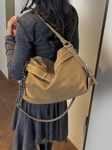 Chic tan large motorcycle tote bag with textured finish and decorative cord charm