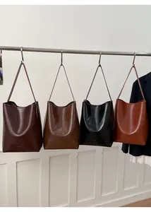 Detail view of large retro bucket tote bags in four colors with oil wax leather texture