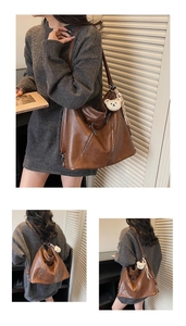Brown vintage faux leather tote bag with stylish side zipper and plush bear charm