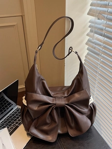 Retro dark brown leather tote bag with a large bow and white lace trim detail