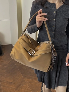 Caramel faux suede large hobo bag with side buckles and tassel for chic commuting