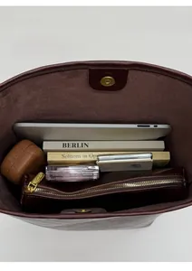 Top view showing the large capacity interior of this leather bucket bag with inner pouch