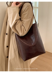 Detail of dark brown vintage oil-wax leather bucket bag showing large capacity and texture