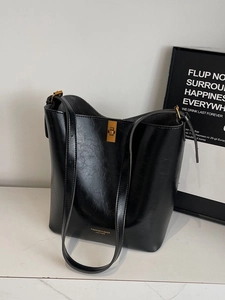 Classic black leather bucket bag with gold clasp and adjustable shoulder strap