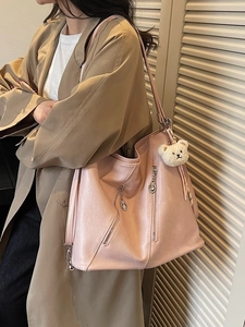 Pink faux leather hobo shoulder bag with plush bear charm and silver zipper detail