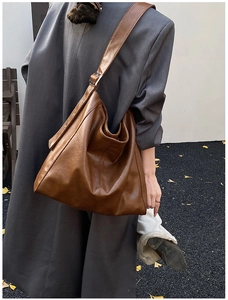 Brown large capacity PU leather hobo tote bag shown on model for a minimal stylish look