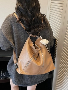 Brown vintage style leather backpack with cute sheep pendant and metal zipper details