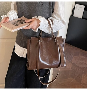 Deep brown vintage tote bag in glossy oil wax leather finish with dual slim straps