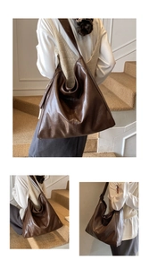 Detail view of large dark brown retro tote bag with wide strap and oiled leather texture