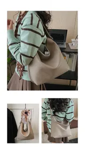 Detail of taupe pebbled leather hobo bag showing integrated shoulder strap and minimalist texture