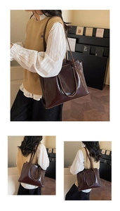 Detail of a large dark brown tote bag in oily leather with premium stitching