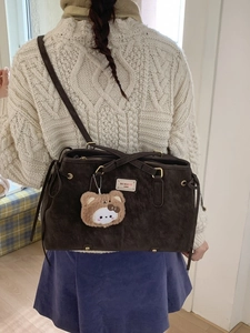Brown suede shoulder tote bag with plush bear charm and spacious retro design
