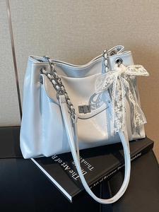 Light blue faux leather tote bag with silver lock, chain strap and white lace bow