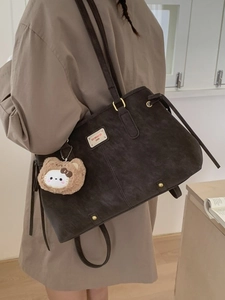 Brown suede tote bag with bear charm and chic shoulder strap for 2025 winter style