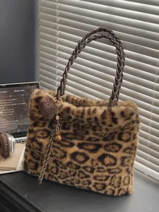 Minimalist leopard print plush tote bag with woven handles and decorative charm detail