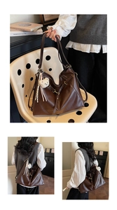Detail view of large dark brown retro tote bag with a cute plush bear pendant accessory